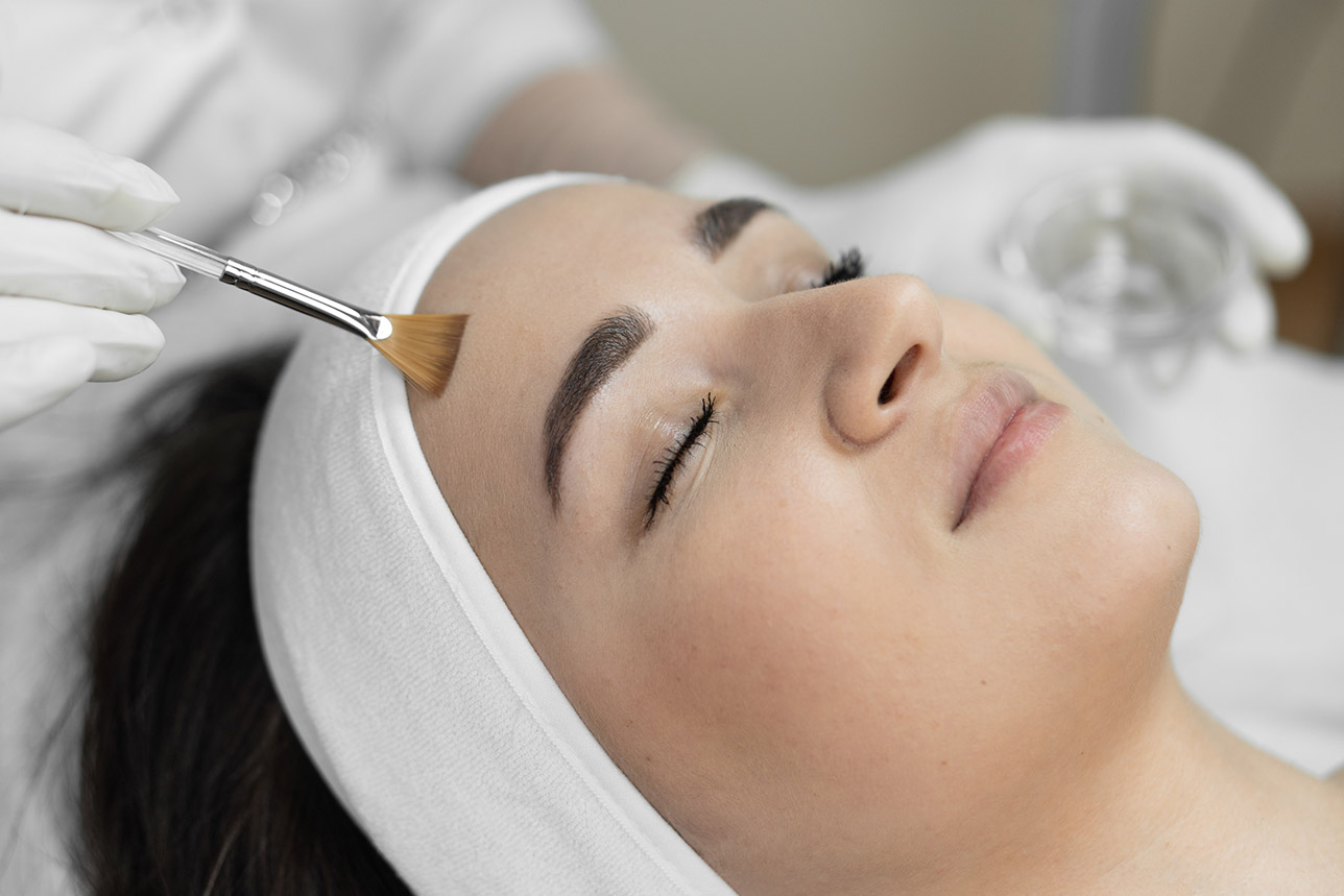 Beautiful woman getting professional grade chemical peel in a med spa.